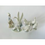 A collection of Lladro Daisa Nao figures including a girl carrying a basket of chicks accompanied by