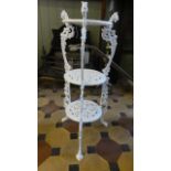 A cast iron three tier floorstanding pot stand with decorative pierced scrolling acanthus and