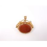 An oversized early 19th century three sided carnelian set fob in unmarked yellow metal with hidden