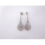 A pair of early 20th century platinum and diamond pendant earrings, each graduated line of mille