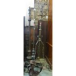 Three Victorian brass and iron lamp standards, further brass fender with geometric detail and a five