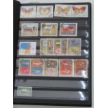 Six stamp album containing an extensive and varied collection of world wide stamps