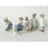 A collection of Lladro Daisa Nao groups including a pair of little girls with a doll, a boy and girl