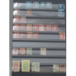 A collection of GB stamps from QV to QE in a black stockbook (displayed in cabinet)