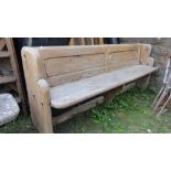 A reclaimed stripped pine church pew with chamfered panelled back, shaped ends and planked seat, 206