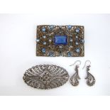 A silver and marcasite open work oval brooch with silver and marcasite drop scrolling earrings