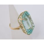 A 50 ct emerald cut aquamarine ladies dress ring with diamond set shoulders in a 4 prong open work