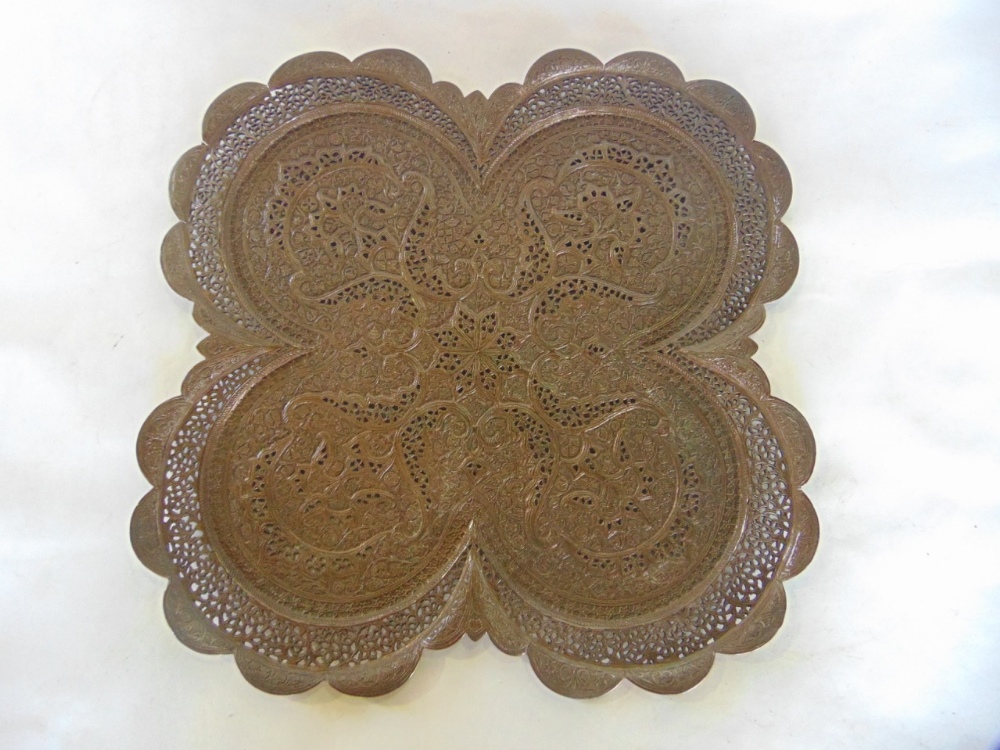 Interesting pierced Eastern bronze shaped tray of quadruped form with embossed scrolled paisley