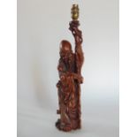 A Chinese carved wood table lamp in the form of a Sage, 47 cm high approx.