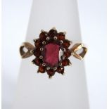 A 9ct gold and red garnet ladies dress ring, ring size L, 2.4g