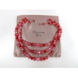 A vintage Christian Dior two strand necklace of carved and molded art glass beads, marked