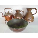 A pair of graduated copper jugs together with a further copper kettle and twin handled pan (4).