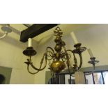 A hollow cast brass six branch Dutch style electrolier with bulbous stem and entwined eagle