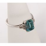 An Art Deco style 18ct white gold ladies ring with central emerald cut blue zircon with diamond