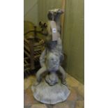 A vintage lead bird bath, the pedestal in the form of a winged cherub supporting a petal shaped bowl