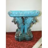 A 19th century turquoise glaze majolica stool in the form of a simulated cushion with tassel