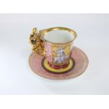 A 19th century Berlin porcelain cabinet cup and saucer with painted central panel of a woman and