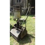 A vintage Atco petrol driven cylinder lawn mower with 14 inch cut.