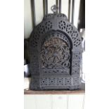 A Rippingilles Patent heater, the cast iron frame of arched form with decorative pierced foliate
