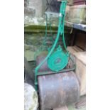 Two similar vintage cast iron garden lawn rollers, one with medallion stamped New Crown trademark,