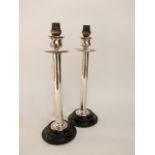 A pair of silver plated cylindrical candlesticks converted into table lamps, 36 cm high (2)