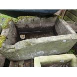 A rectangular natural stone trough