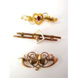 Two 9k gold early 20th century bar brooches together with one unmarked yellow metal gem set bar