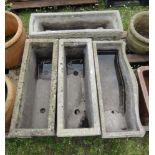 Four various weathered reconstituted garden planters, all with decorative panels, 70 cm long