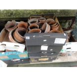 A large quantity of weathered terracotta flower pots of varying size together with a Victorian