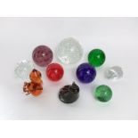 A collection of glass coloured paperweights/dumps, one in the form of a squirrel another in the form
