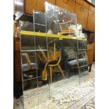 Art Deco period bevelled glass overmantle mirror of geometric form, 123 cm x 123 cm