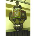 A Moroccan style lantern of octagonal form with coloured glass panels.