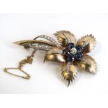 An early 20th century unmarked yellow and white metal diamond and sapphire flower brooch, set with