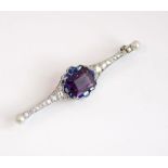 A platinum, diamond, amethyst, sapphire and pearl Art Deco pin brooch, large central emerald cut