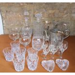A mixed collection of cut glassware to include two decanters, cut glass tankard, and further cut