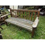 A weathered teak three seat garden bench with slatted seat and back, 5ft long approx.
