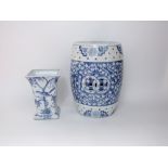 An oriental blue and white garden seat with prunus blossom decoration, 43cm tall approx together