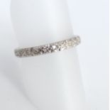 An unmarked white metal and illusion set diamond eternity ring, size O, 2.9gm