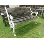 An iron work garden bench with lion mask detail and weathered timber lathes.