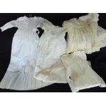 A box containing a collection of antique linen and lace, to include three christening gowns