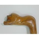 Early primitive carved Grecian walking stick, the handle in the form of a recumbent lion, 78cm long