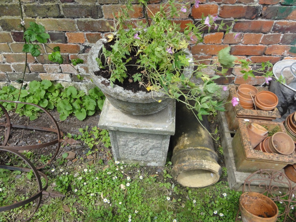 A weathered composition stone garden urn with circular waisted bowl raised on a square pedestal with - Image 2 of 2