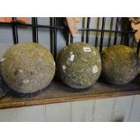Three reconstituted and weathered ball shaped finials, 20 cm diameter approx.
