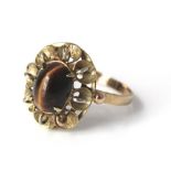 A 14k gold ladies flower ring set with central tigers eye cabochon, ring size N, 2.3g