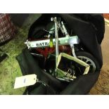 A folding 'Batribike' in original holdall, with branded accessories