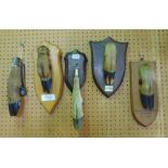 Collection of trophy deer hooves four fitted on oak plaques another in the form of a door knocker,