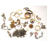 A collection of costume jewellery to include yellow metal bangles, white and yellow metal chains,