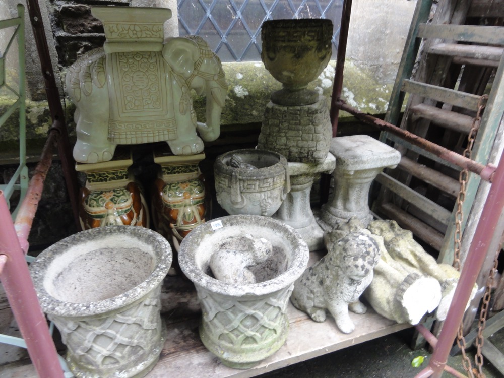 A pair of weathered cast composition stone garden planters of circular waisted form with lattice