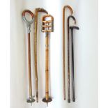 A collection of walking canes to include bamboo cane with 9ct gold tip, two shooting sticks and