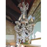 A good gilt cast metal six branch chandelier with prismatic glass drops.